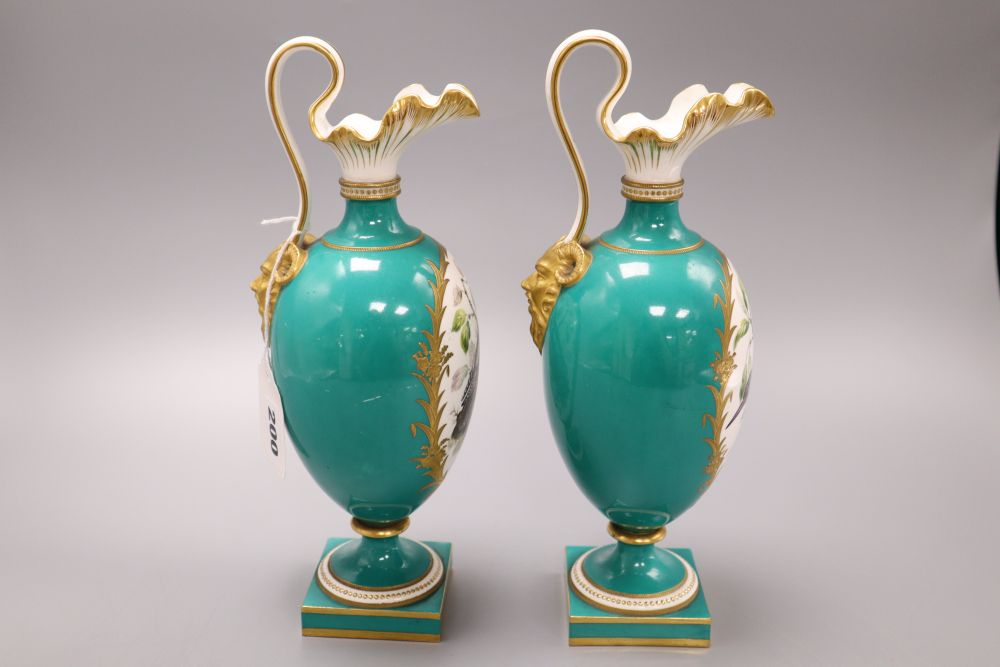 A pair of Coalport green glazed ewers, hand painted birds to the body, height 27cm